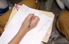Participant recording data and observations on paper