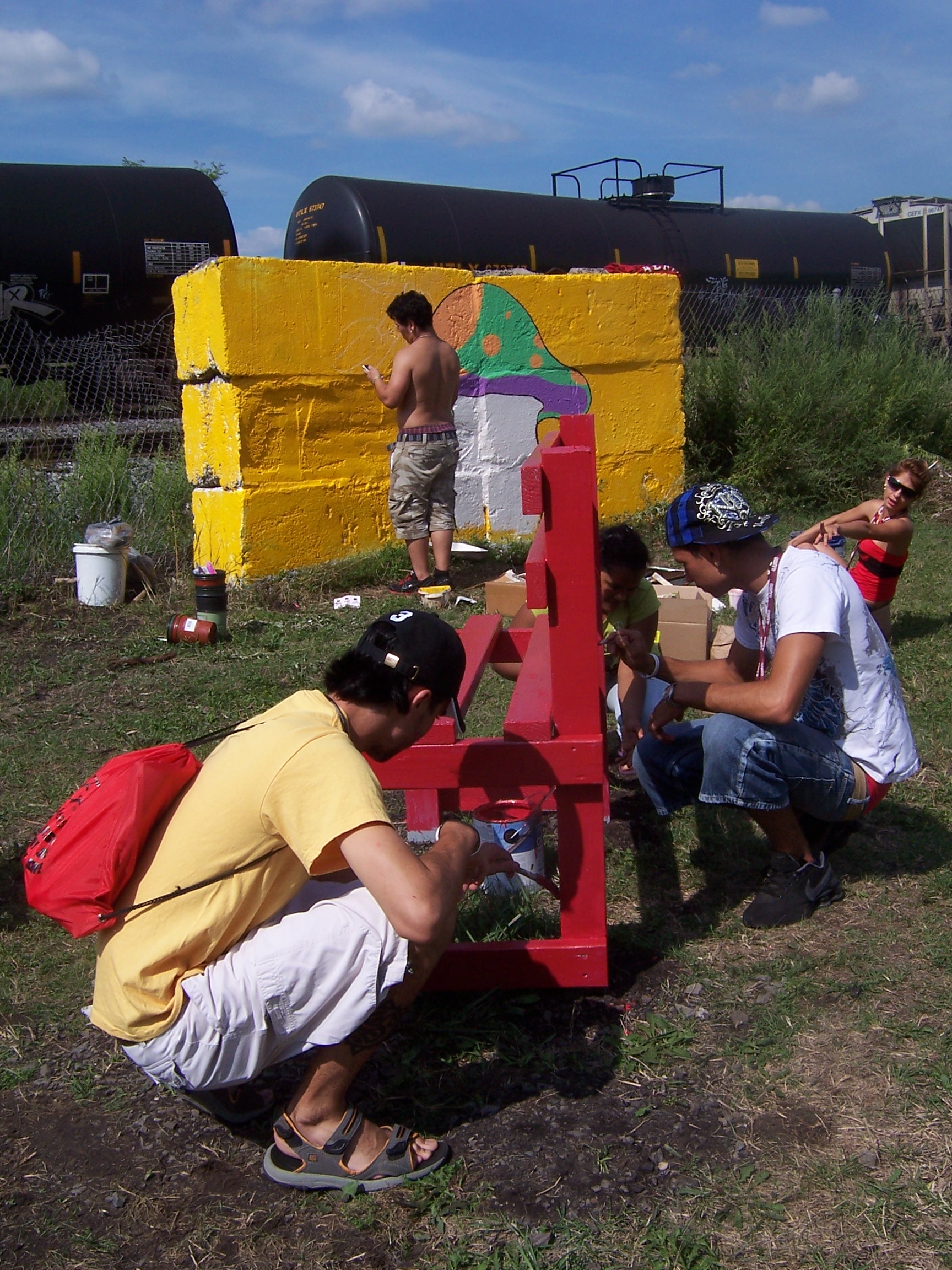 Participants Painting a Bench and Mural