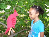 Girl with paper bird on tree